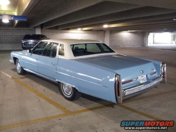 Light blue 1977 Cadillac sedan, 3q-front view, white vinyl roof, Texas license plate