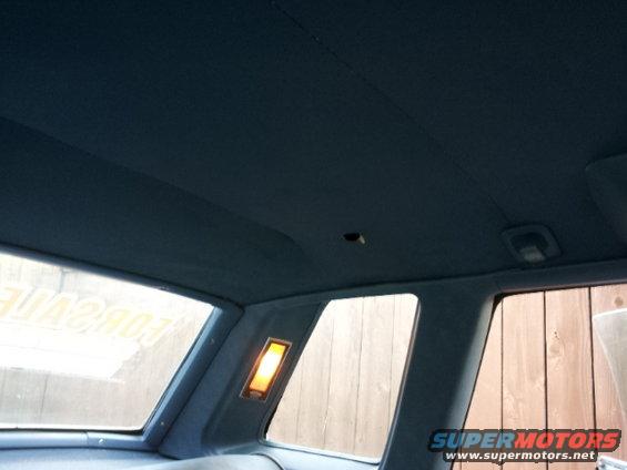 Interior view of car ceiling, showing headliner and rear side windows. Text 'FOR SALE' visible in window