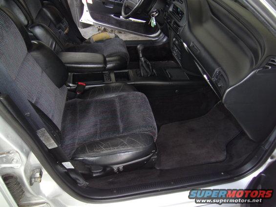Car interior showing front seats, dashboard, and center console