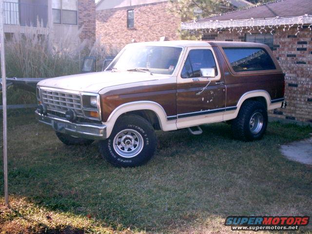 Two-tone brown and cream 1980 Ford Bronco with wood paneling