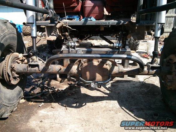 custom rear axle with large shocks and sway bar on a heavily modified off-road vehicle