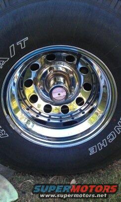 Chrome wheel with black tire, text 'BFGOODRICH ALL-TERRAIN T/A' visible on tire sidewall