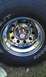 1987 Ford Bronco - Close-up of a chrome wheel and tire with visible text on the sidewall.