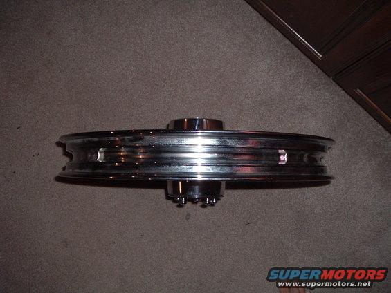 Chrome motorcycle wheel with spokes visible on hub
