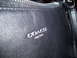 1993 Ford Probe - Close-up of a black leather handbag the COACH NEW YORK logo and zipper.