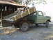 1979 Ford Bronco - This dump truck, likely from 1979, is seen from the side, carrying a load of firewood.