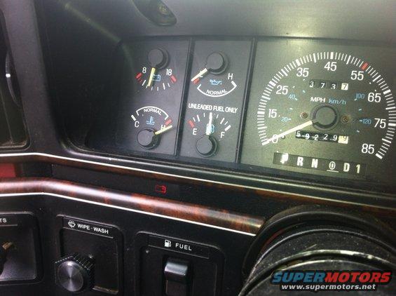 Dashboard gauges showing fuel, oil, temperature, and speedometer. Odometer reads 59229. Gear selector shows P R N D 1