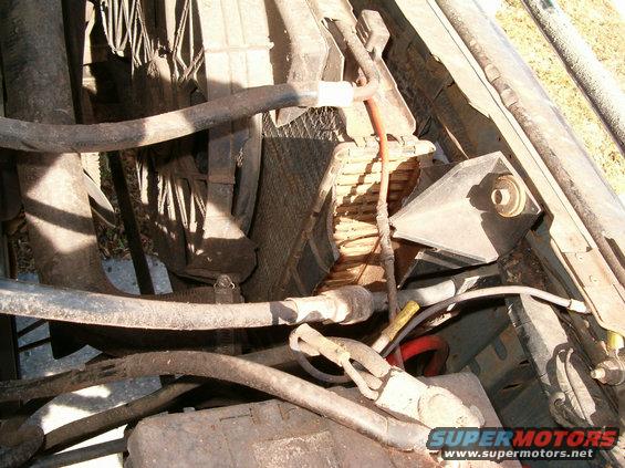 Engine bay with damaged radiator and hoses