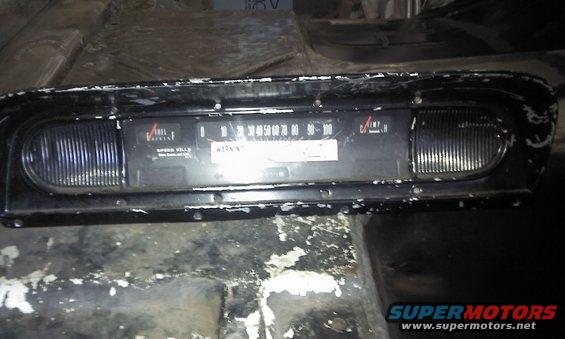 Black dashboard instrument cluster with speedometer and fuel gauge