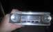 1966 Oldsmobile Cutlass - A vintage car radio, possibly for an Oldsmobile, is held in a hand.