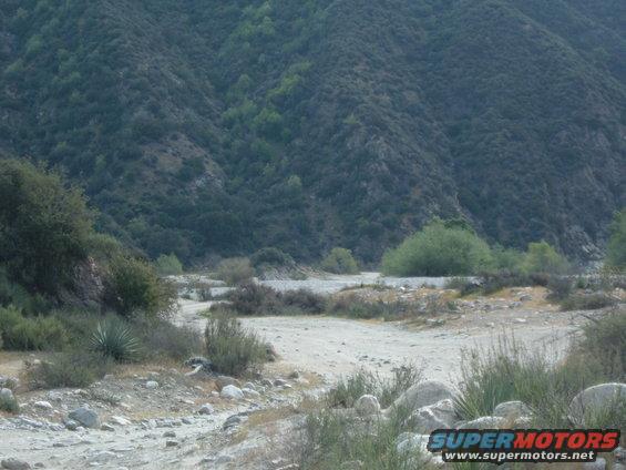 Dry riverbed with mountains and brush