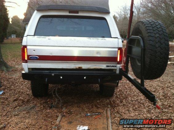 White Ford Bronco Centurion with external spare tire mount, rear view