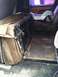 1992 Ford C-350 (Centurion Conversions) - The interior of a van shows a folded seat and a child's car seat, suggesting a utilitarian or family use.