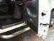 1992 Ford C-350 (Centurion Conversions) - Interior view of a truck's open door, revealing the driver's side floor and door panel.