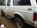 1992 Ford C-350 (Centurion Conversions) - This white SUV has a "4x4" decal on its side and is covered in mud.