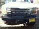 1992 Ford C-350 (Centurion Conversions) - This Ford truck features a heavy-duty bumper, brush guard, and a winch, along with a playful smiley face license plate.