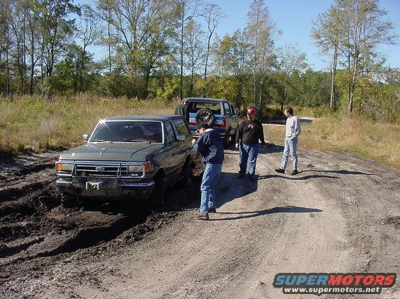 Gray 1991 Ford Bronco stuck in mud, front view