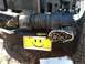 1992 Ford C-350 (Centurion Conversions) - A winch is mounted to the front bumper, with exposed gears and a smiley face license plate.