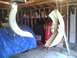 2003 Ford Crown Victoria - Car fender parts are suspended in a garage, awaiting work or installation.