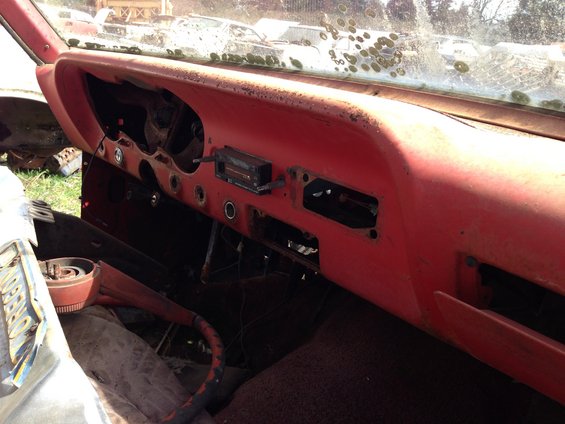Red dashboard interior with radio and missing gauges