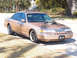 1993 Ford Crown Victoria - This heavily modified Ford sedan features an exposed engine and custom wheels, suggesting it's not a standard 1993 model.