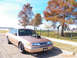 1993 Ford Crown Victoria - This modified 1993 Ford Crown Victoria features an exposed engine, parked near a playground.