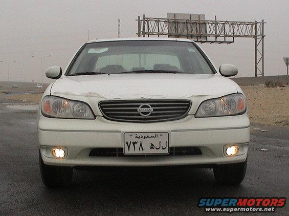 White 2004 Nissan Maxima front view with headlights on