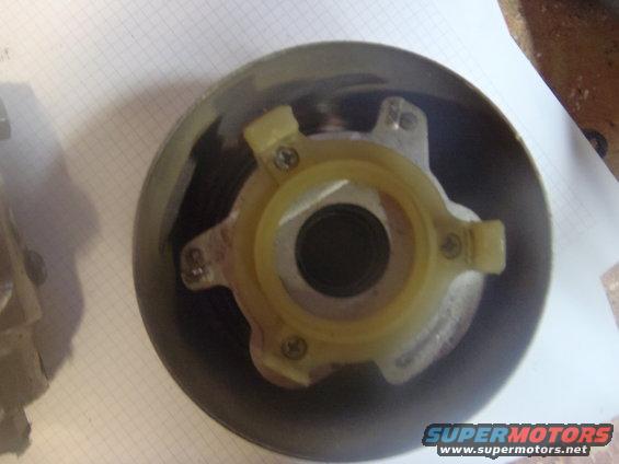 Clutch pressure plate with yellow plastic centering ring and metal mounting tabs