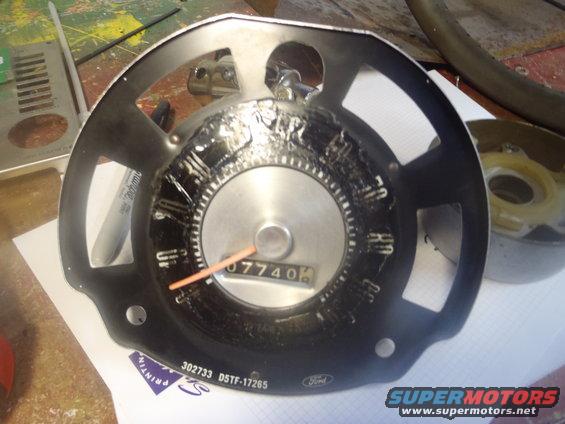Ford instrument cluster with odometer showing 07740. Part number 302733 D5TF-17265 visible