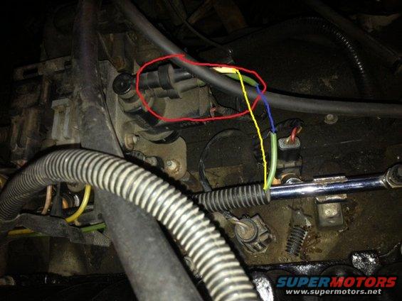 Engine bay wiring and vacuum lines, one connector circled in red