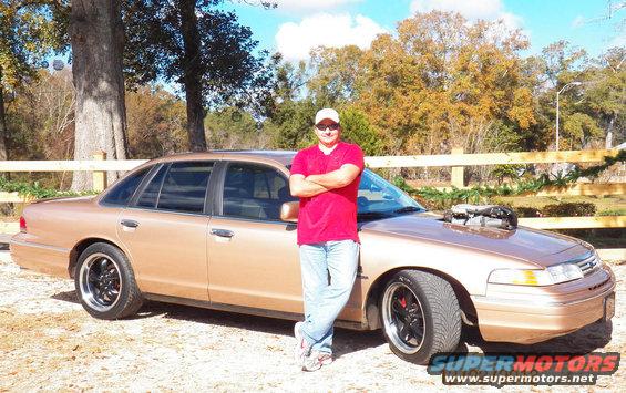 Gold 1993 Ford Crown Victoria with hood scoop and custom wheels