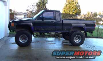 1987 Toyota pickup truck, side view, lifted suspension, aftermarket wheels