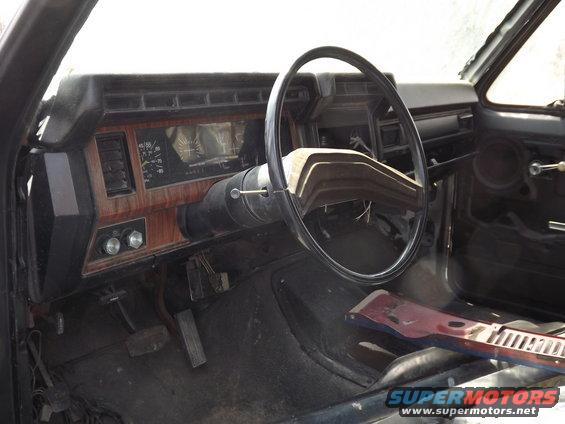 1981 Ford Bronco interior showing dashboard, steering wheel, and pedals