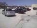 2003 Ford Crown Victoria - A silver 2003 Ford Crown Victoria is parked in a lot with other vehicles.