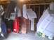 2003 Ford Crown Victoria - Various car body parts are suspended and appear to be undergoing a painting process in a garage setting.