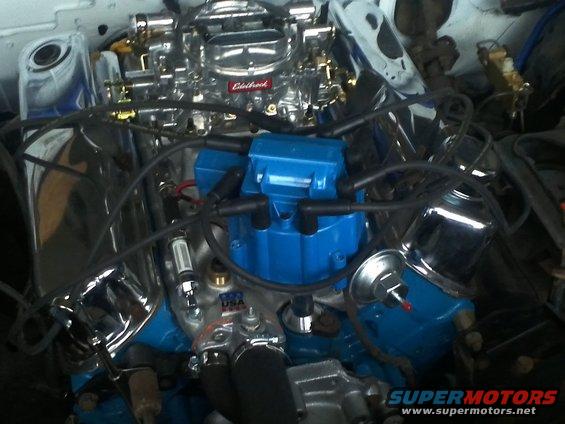 Engine bay with Edelbrock carburetor and blue distributor cap