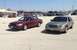 2005 Ford Crown Victoria - Two Ford Crown Victoria sedans are parked side-by-side in an outdoor lot under a clear sky.