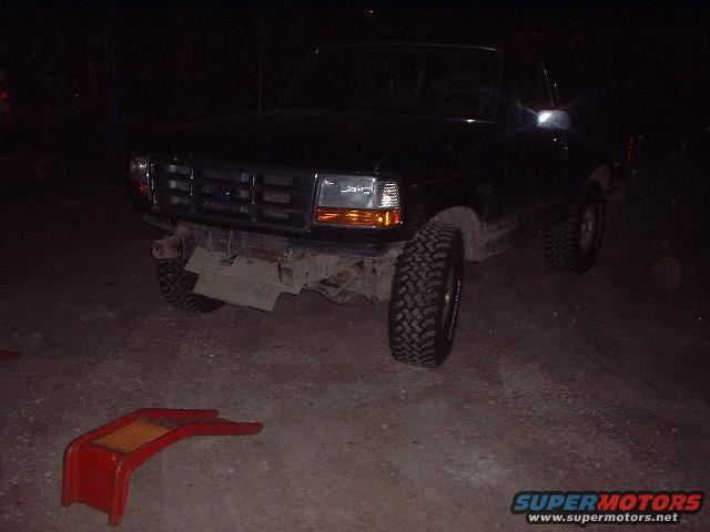 1993 Ford Bronco front view, bumper removed, parked at night