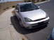 1993 Ford Probe - Silver hatchback parked on a street with a concrete curb and sidewalk.