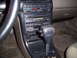 1993 Ford Probe - The center console of a car features an automatic transmission shifter and various climate and audio controls.