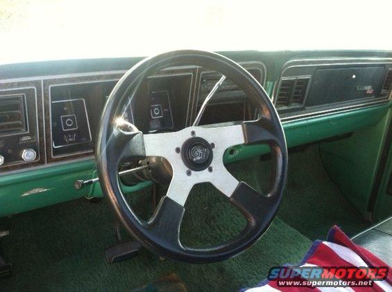 1977 Ford F-350 interior showing aftermarket steering wheel and green dashboard
