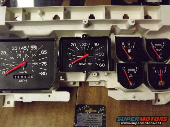 Dashboard instrument cluster with speedometer, tachometer, fuel, and temperature gauges. Odometer shows 219147