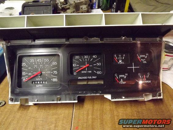 Vehicle dashboard gauges including speedometer, tachometer, fuel, oil, temp, and charge indicators