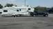 2011 Ford F-250 - 2011 Ford F-250 Super Duty truck is seen towing a large fifth-wheel recreational vehicle.