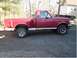 1992 Ford F-150 - This red Ford F-150 pickup truck is shown from the side, parked outdoors.