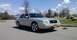 2008 Mercury Grand Marquis - A tan 2008 Mercury Grand Marquis is parked on an asphalt lot under a partly cloudy sky.