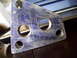 1993 Ford Probe - A close-up of a metal bracket with multiple holes and visible scratches.