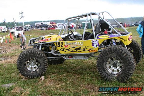 Yellow custom buggy with roll cage and large off-road tires, number 192 on door