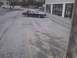 2003 Ford Crown Victoria - A two-tone sedan is parked in a lot next to a building.