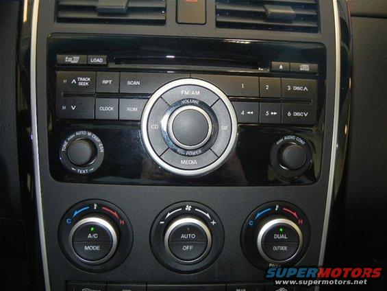 Black dashboard interior of a 2008 Mazda CX-9 showing the center console with radio and climate controls